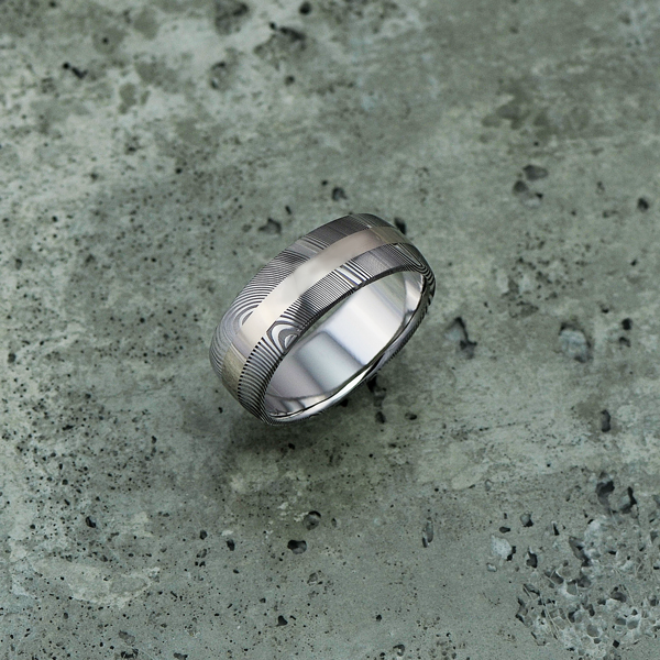 Damascus steel ring with an 18ct white gold central inlay, in a light etch and round profile. $1550 + shipping.